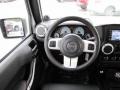 2012 Jeep Wrangler Unlimited Black with Polar White Accents/Orange Stitching Interior Steering Wheel Photo