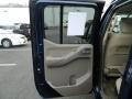 Beige 2010 Nissan Frontier LE Crew Cab 4x4 Door Panel