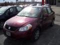 2009 Cherry Red Metallic Suzuki SX4 Sedan LE  photo #5