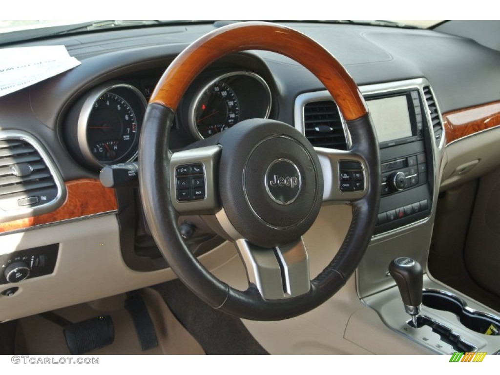 2011 Jeep Grand Cherokee Overland 4x4 Dark Frost Beige/Light Frost Beige Steering Wheel Photo #89837729